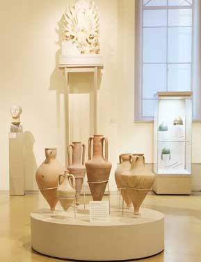 Ancient pottery displayed in a museum room.