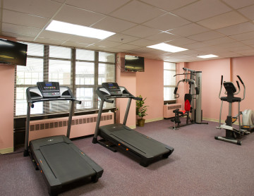 gym room with treadmill and cycle