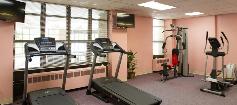 gym room with treadmill and cycle